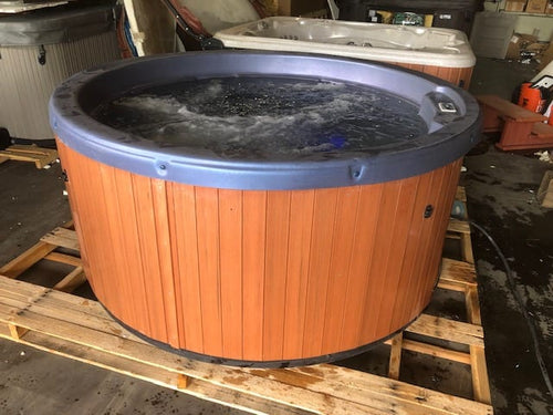 Used 2011 Caldera Lina Round Spa with Blue Pebble Shell and Synthetic Siding