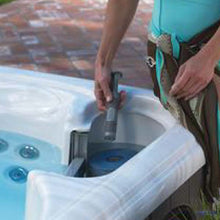 Load image into Gallery viewer, Person inserts Silver Ion into Hot Tub - Silver Ion Reno, Sparks, San Jose, Santa Cruz
